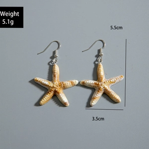 Close-up of starfish drop earrings with measurements showing weight and size details