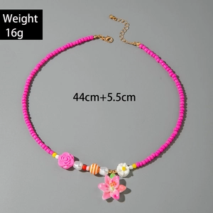 Detail showing pink beaded necklace with floral charms and lobster clasp closure
