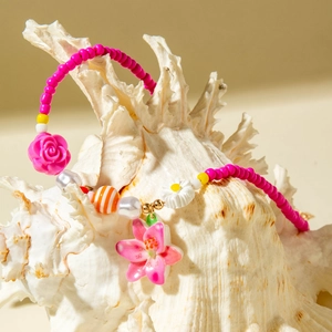 Close-up of vibrant summer beaded necklace with starfish and tropical flower pendant