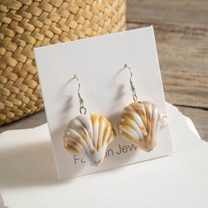 Detailed view of striped resin shell drop earrings on a display card with ocean style