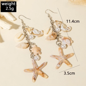 Detail of beach style drop earrings with seashell, starfish and seahorse charms