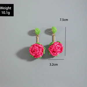 Macro detail of leaf-shaped woven earrings showing dimensions 7.5cm by 3.2cm and 10.1g weight
