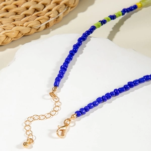 Detail of colorful beaded necklace with blue beads and adjustable gold clasp lobster hook