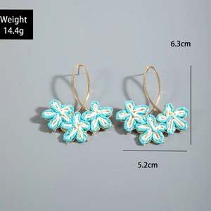 Detail showing weight 14.4g and dimensions 6.3x5.2cm for leaf raffia earrings