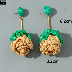 Detailed size view of leaf-shaped woven raffia earrings measuring 8.2cm by 3.2cm