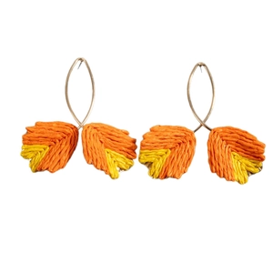 Handmade woven raffia leaf earrings in orange and yellow with gold hooks for beach style