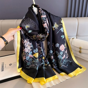 Floral print silk scarf with black base and yellow borders for a stylish summer look