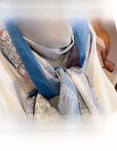 Detail of blue and white plant print scarf with red flowers in linen-like twill fabric