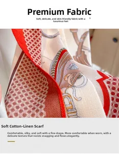 Detail of elegant silk-like scarf featuring geometric patterns and red rolled edges