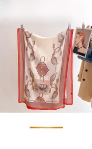 Detailed view of luxury horse-carriage print silk scarf on a stylish display