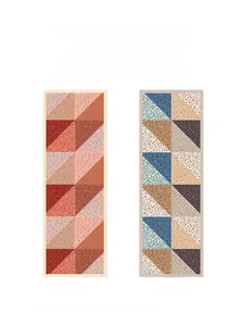 Detail of long silk scarf showing geometric patchwork patterns on front and back sides