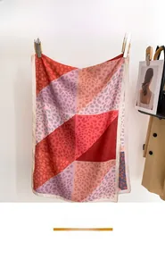 Detail of thin summer silk scarf featuring geometric color block patterns and plant dye texture