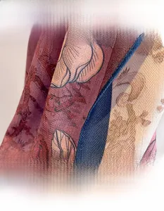 Detail shot of elegant floral print scarf with herringbone texture and soft linen-feel fabric