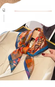 Detail of printed thin square scarf styled on a beige suit neck for an elegant look
