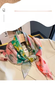 Close-up of floral silk scarf with oil painting pattern styled on a beige suit lapel