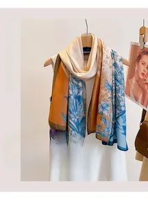 Detail of vintage floral print scarf draped on a wooden hanger for sun protection