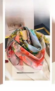 Detail of silk cotton square scarf with oil painting floral print hanging on a hanger