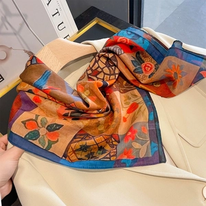 Retro color-block floral silk scarf draped on a beige blazer for a stylish summer look