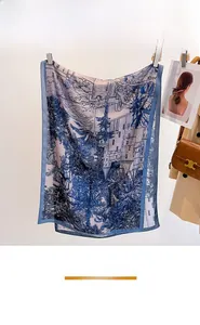 Detailed view of the thin summer silk scarf featuring blue and white landscape prints