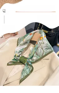 Detail of tropical floral silk blend scarf styled on a beige blazer lapel