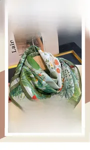 Detail of silk cotton square scarf with tropical green plants and orange floral patterns