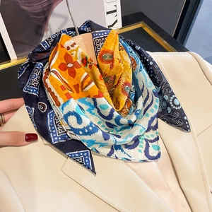 Chinese style patchwork silk scarf with paisley floral pattern on a formal blazer
