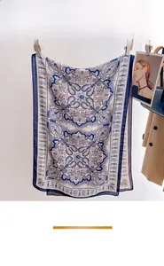 Detail of a lightweight blue and purple paisley scarf hanging with elegant print patterns