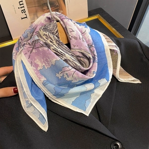 Elegant silk scarf with blue and purple Japanese floral print on a black blazer