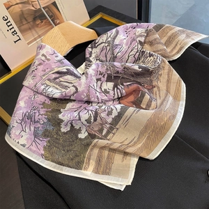 Silk square scarf with horse and landscape print draped over a black blazer
