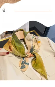Detailed view of lightweight silk-like floral scarf tied elegantly on a cream blazer