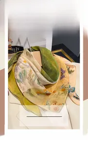 Detail of floral printed neck scarf draped on a suit jacket lapel with artistic butterfly motifs