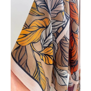Fashionable sun protection beach shawl with retro botanical leaf print in vibrant silk fabric