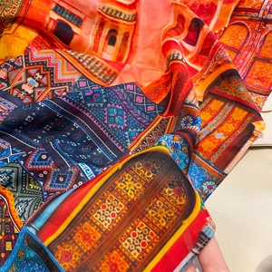 Detailed close-up of exotic patterned silk scarf with intricate geometric print