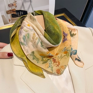 Elegant vintage French floral silk scarf with butterfly print styled on a beige suit blazer