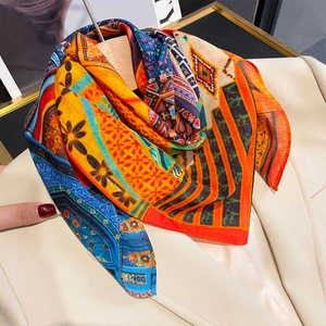 Bohemian patterned silk scarf with vibrant geometric prints on a beige blazer