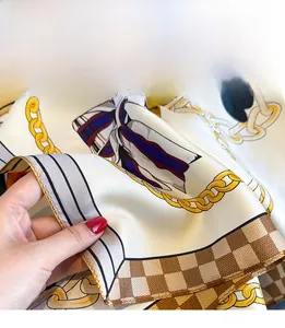 Close-up of premium silk scarf showing meticulous chain stitch hem and chain pattern