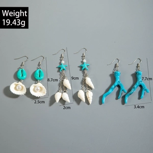 Detailed view of ocean-themed earrings including shell, starfish, and coral designs