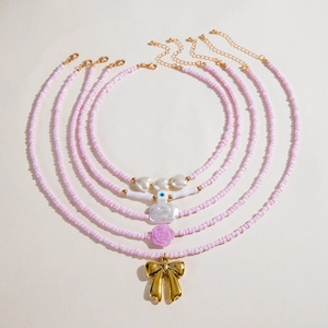 Five-piece pink beaded necklace set with heart pearl and golden bow charms