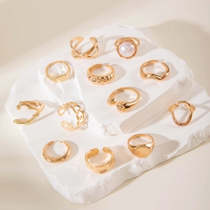 Detail view of 11-piece vintage gold-tone ring set featuring irregular pearls and textures