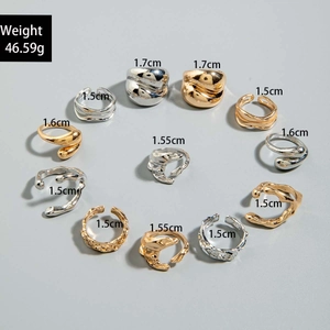 Detailed view of gold and silver irregular lava rings set with dimension labels