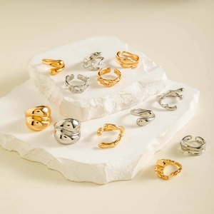 Detailed view of vintage gold and silver lava style irregular rings on stone displays