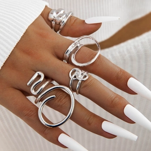 Set of abstract geometric silver rings with irregular twisted and open-loop designs