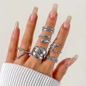 Detail of silver lava style molten rings with high polish finish on a model's hand