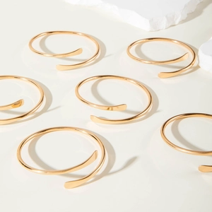 Minimalistische stapelbare goldene Spiralarmreifen mit flachen Enden für Damen