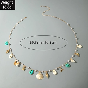 Detail of shell and starfish pendants on a beaded waist chain with size markings
