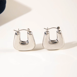 Detailed view of silver U-shaped metal hoop earrings with high-polish mirror finish