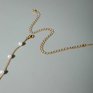 Detail of gold bead waist chain with pearls, lobster clasp and adjustable extension chain