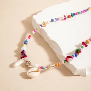 Detail of bohemian beach waist chain featuring colorful beads, shells and crystal charms