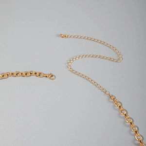 Detail of gold beach body chain with secure lobster clasp and adjustable extension link