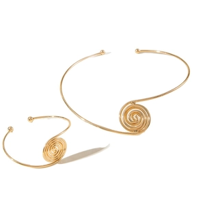 Golden snake chain necklace and bracelet set featuring minimalist geometric spiral pendants